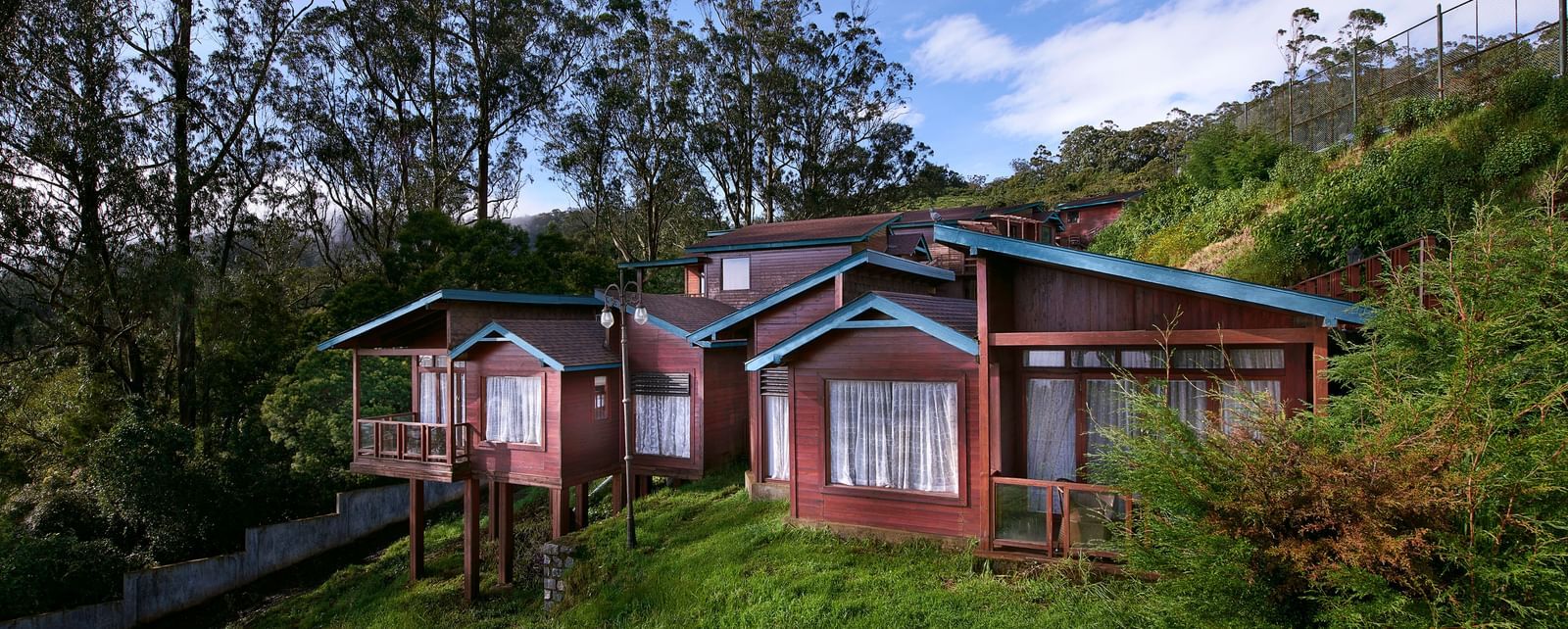 An image of a villa set amidst the hills filled with plants and trees - Accord Hotels and Resorts